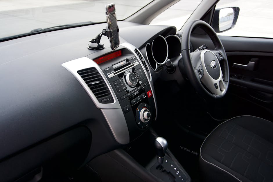 Sleek car dashboard with smartphone mount, steering wheel, and controls. Ideal for modern automotive design themes.